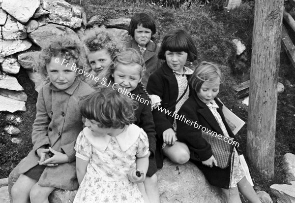 CHILDREN WAITING IN GROUP AT SIDE OF ROAD